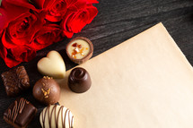 chocolates, roses, and paper for a love letter 