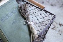 Bible songs book and lavender in a wire basket 