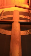 wood cross behind an altar 
