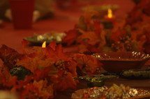 red and orange fall leaves on a Thanksgiving table 
