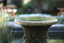 fountain in a koi pond 