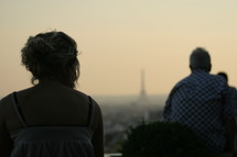 tourists looking out at the Eiffel Tower in the distance