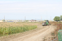 a tractor in a corn field 