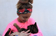 a girl holding a cat 