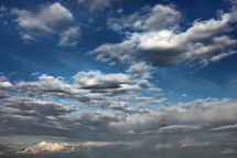 parachutist flying on the background of the beautiful sky. skydiver in the sky. a lone parachute among beautiful clouds. Active Hobbies.