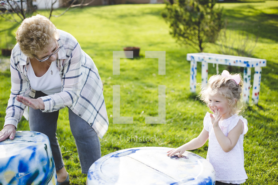 grandmother playing outdoors with her granddaughter 