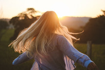 Women looking at the sunset on a filed