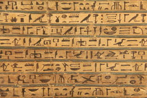 Egyptian hieroglyphics painted onto a stone tablet