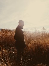 man walking in a wheat field 