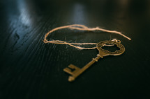 skeleton key on a string on a floor 