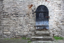 Arched doors in a stone wall doorway