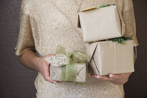 a woman holding Christmas gifts 