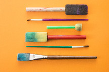 paint brushes on yellow 
