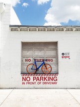 No Parking sign and a parked bicycle 