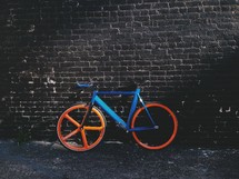 bicycle leaning against a wall 