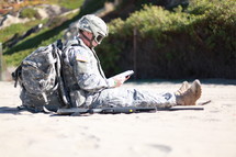 soldier sitting reading 