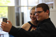 Teen couple taking a selfie.