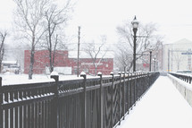 snow on a bridge and railings 