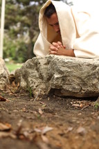 Jesus kneeling in prayer