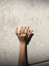 woman's hand with rings 