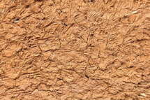 Red clay wall texture on African hut 