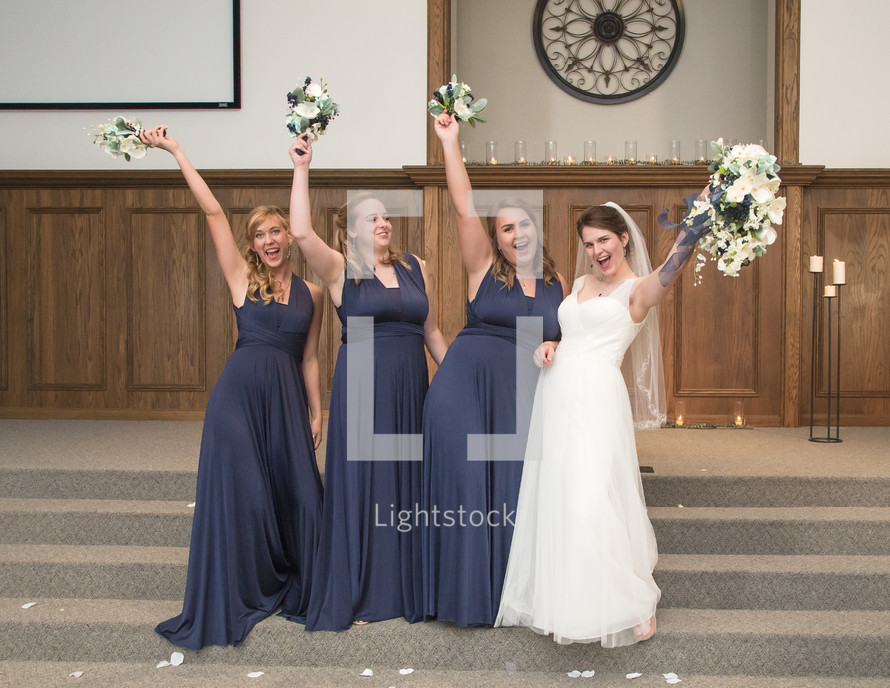 bride and bridesmaids with bouquets 