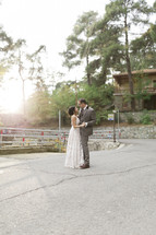 bride and groom dancing outdoors 