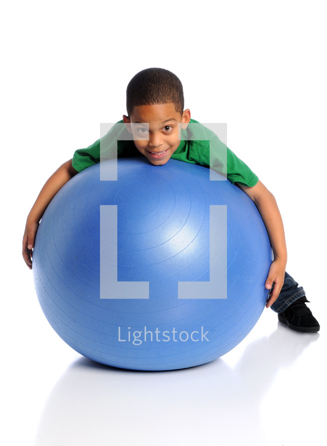 boy playing with a large blue ball 