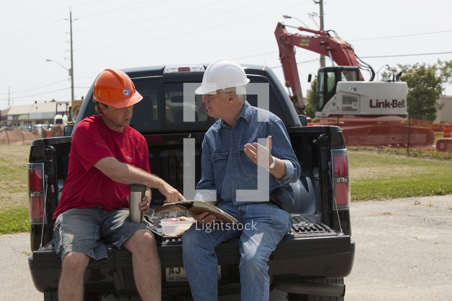 contractors planning in the back of a truck 