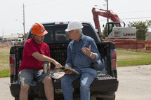 contractors planning in the back of a truck 