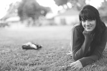 smiling teen laying in the grass