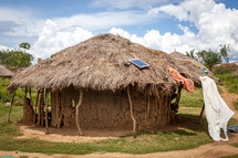 thatched roof hut with a solar panel 
