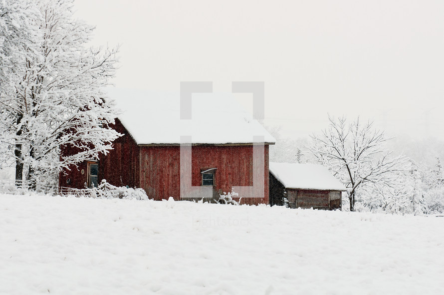 a barn covered in snow 