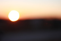 blurry sun at sunrise