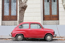 Small red car parked on a street