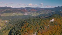 Aerial view of autumn forest mountains in countryside nature landscape
