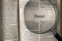 magnifying glass over Bible - Daniel 