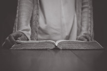 a person sitting reading a Bible 