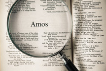 magnifying glass over Bible - Amos 