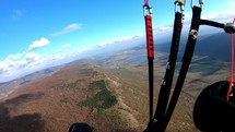 Paragliding adrenaline flight above autumn mountains.