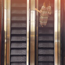 a woman on an escalator 