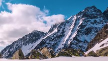 Clouds time lapse in winter mountains in cold alpine snowy nature landscape in sunny day
