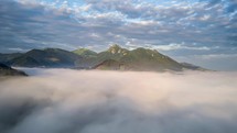 Epic fly above clouds in morning mountains Time lapse

