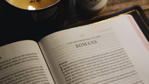 Rack focus on Bible open to Romans