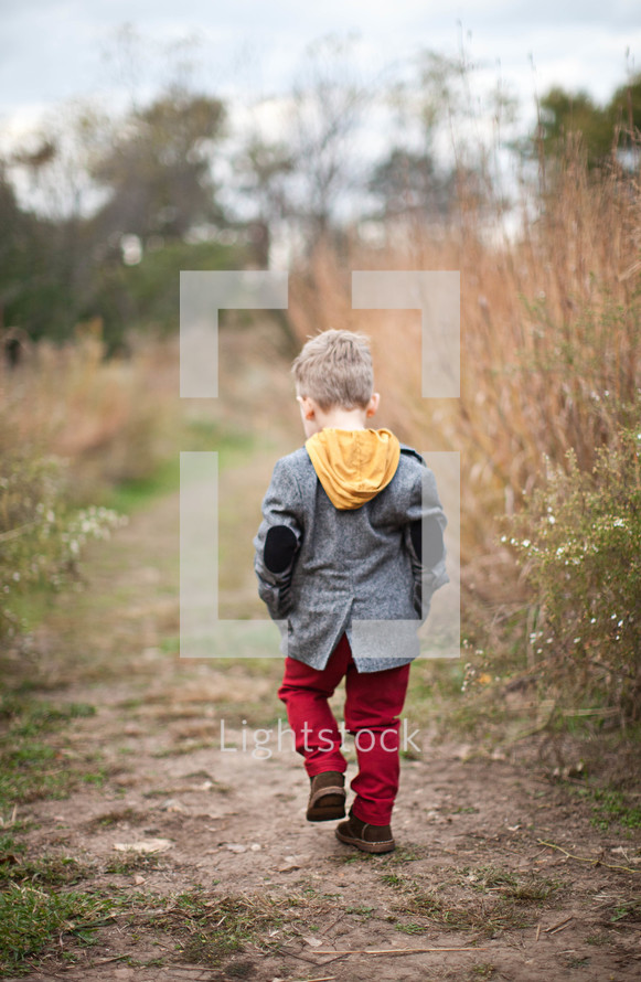 toddler boy walking outdoors 