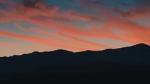 Mountains silhouette under Stunning red Clouds 