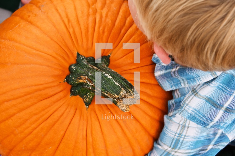 Boy holding a pumpkin
