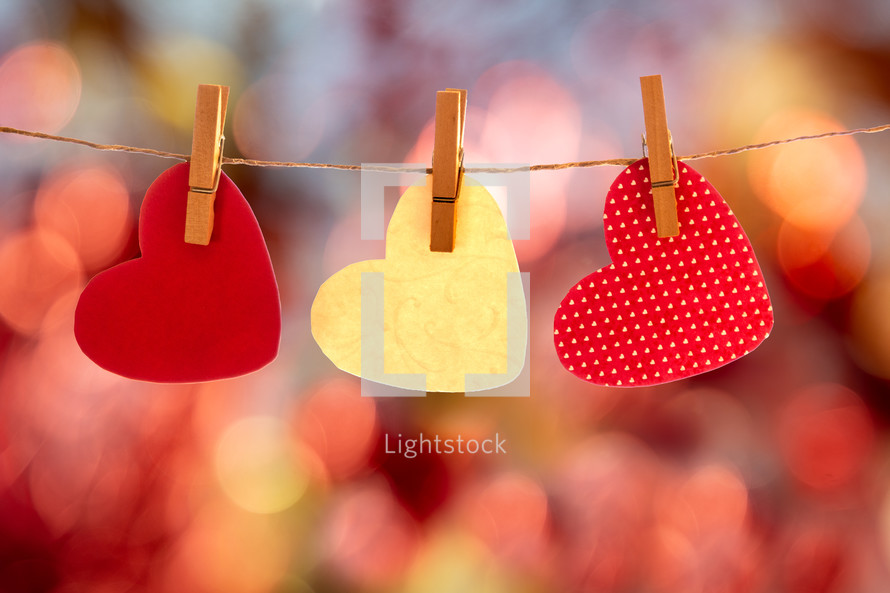 paper hearts on clothespins and bokeh background 