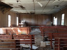 Abandoned chuch littered with debris.