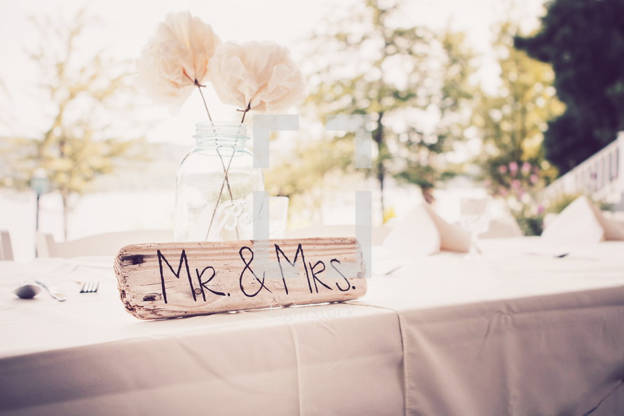 Mr and Mrs sign and white tablecloth on a table 